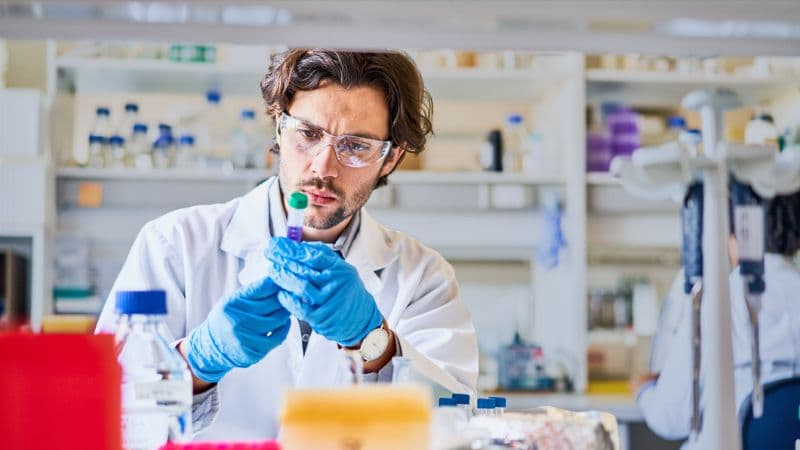 Young Scientist Examining A Research Sample In A Lab