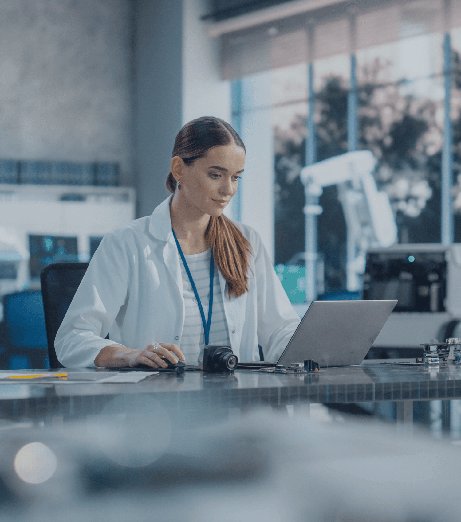 EPM Biometrics Portrait Of Professional Female Scientist Working In Industrial Lab Using Laptop Computer.