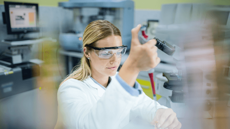Young Female Chemist Working With Chemicals In Laboratory