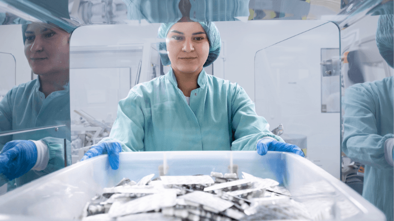 Pharmaceutical Laboratory Employee Holding Box With Blister Packs